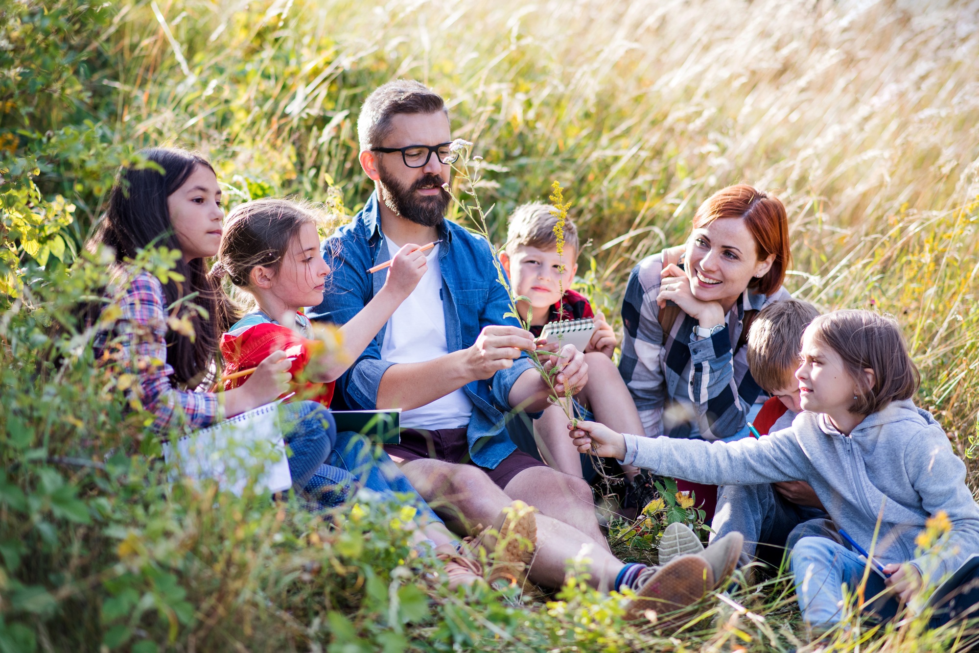 Group of school children with teacher on field trip in nature